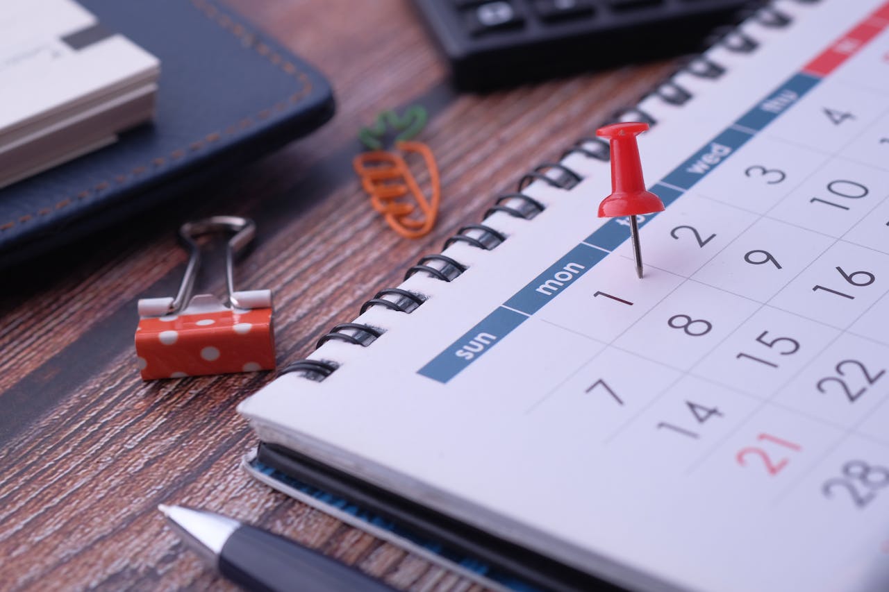 contact-img Desk elements like calendar and pins for effective planning.
